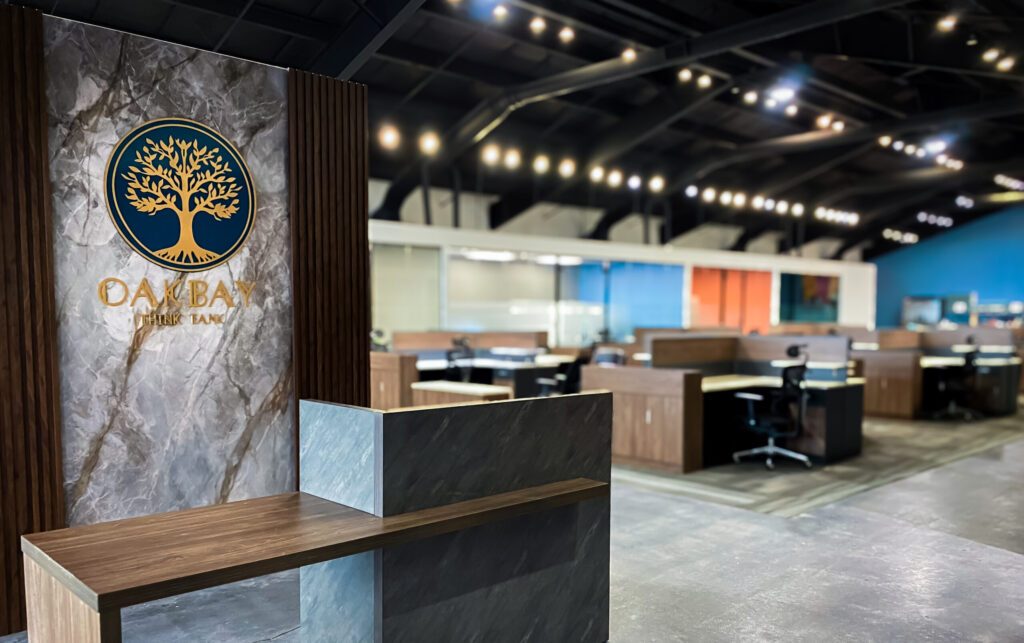 A photo of the reception desk with Oakbay's main floor area in the background